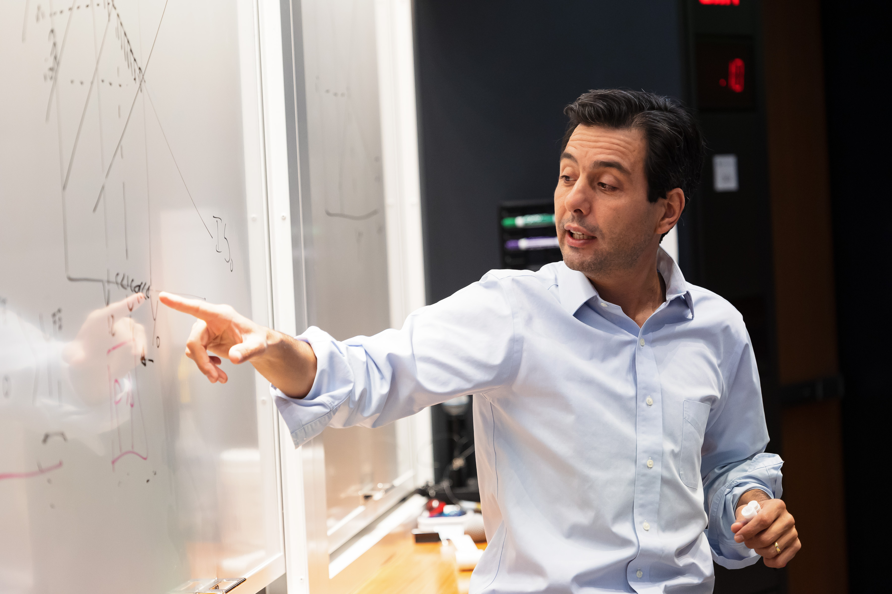 Lorenzo Caliendo lecturing at a whiteboard