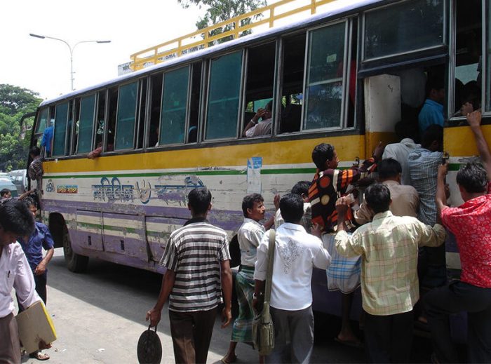 "Migrant workers board the bus to the city."