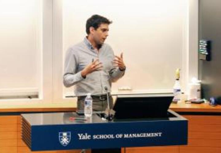 Yusuf Neggers at podium at Yale School of Management